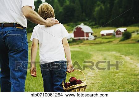 Father and son walking on farm View Large Photo Image Picture - Father and son walking on farm. Fotosearch