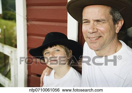 Father and son wearing cowboy hats View Large Photo Image Stock Photograph - Father and son wearing cowboy hats. Fotosearch