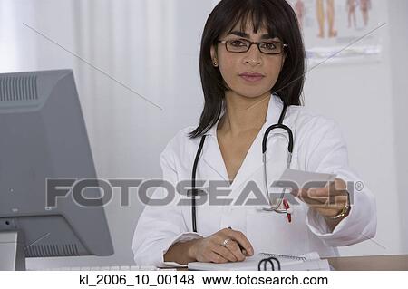 Stock Photo - Female doctor handing over prescription. Fotosearch