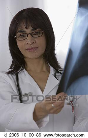Stock Photograph - Female doctor holding x-ray. Fotosearch