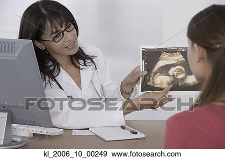 Female doctor showing sonogram to patient View Large Photo Image Stock Photo - Female doctor showing sonogram to patient. Fotosearch