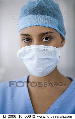 Female doctor wearing surgical mask View Large Photo Image Stock Image - Female doctor wearing surgical mask. Fotosearch