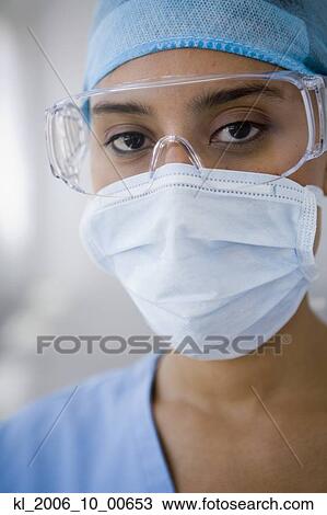 Female doctor wearing surgical mask View Large Photo Image Stock Image - Female doctor wearing surgical mask. Fotosearch