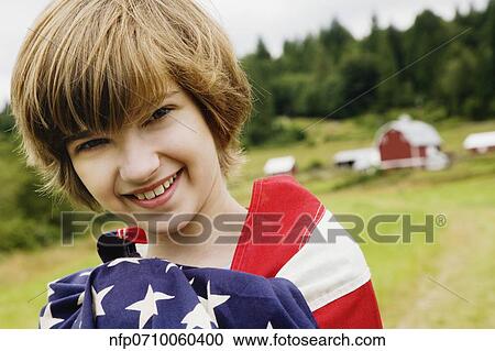 Girl wrapped in American flag on farm View Large Photo Image Stock Image - Girl wrapped in American flag on farm. Fotosearch
