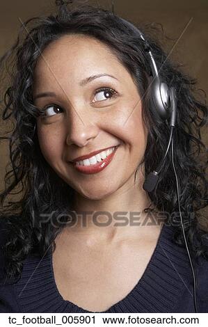 Stock Image - Hispanic businesswoman wearing headset. Fotosearch