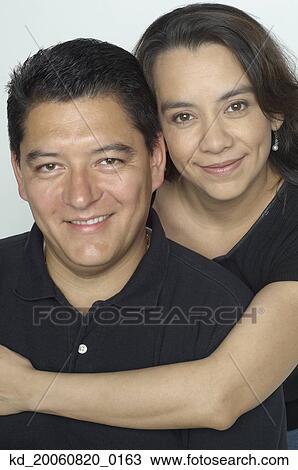 Hispanic couple hugging View Large Photo Image Stock Image - Hispanic couple hugging. Fotosearch