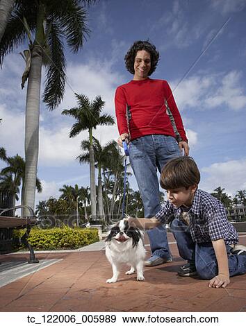 Hispanic father and son with dog View Large Photo Image Stock Photo - Hispanic father and son with dog. Fotosearch