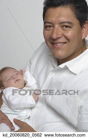Hispanic father holding baby View Large Photo Image Stock Image - Hispanic father holding baby. Fotosearch