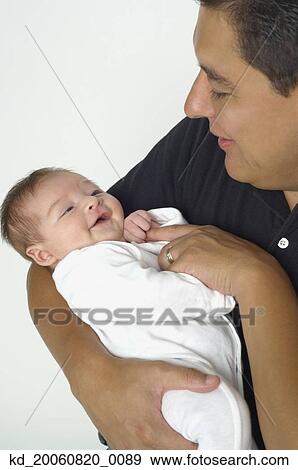 Stock Photo - Hispanic father smiling at baby,. Fotosearch
