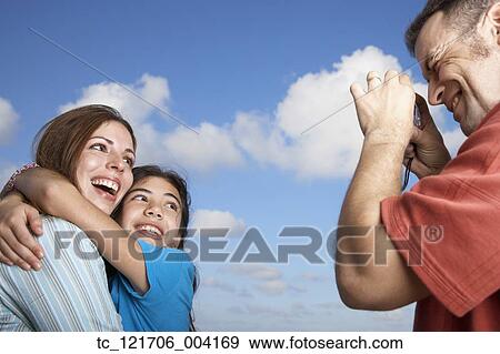 Hispanic father taking photograph of family View Large Photo Image Stock Photo - Hispanic father taking photograph of family. Fotosearch