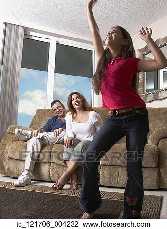 Stock Image - Hispanic girl dancing for parents. Fotosearch