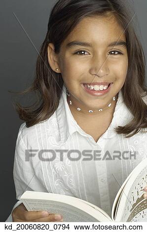 Picture - Hispanic girl holding book. Fotosearch