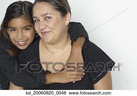 Hispanic girl hugging mother View Large Photo Image Stock Photo - Hispanic girl hugging mother. Fotosearch