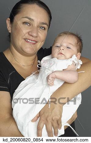 Picture - Hispanic grandmother holding baby. Fotosearch
