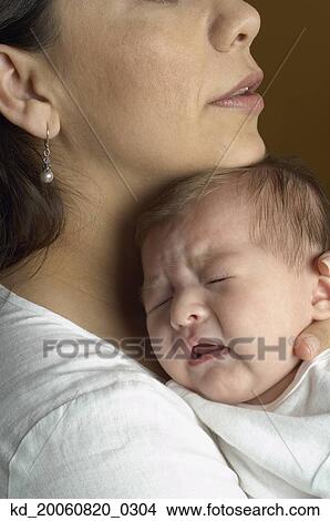 Picture - Hispanic mother hugging baby. Fotosearch