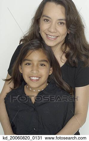 Hispanic mother hugging daughter View Large Photo Image Stock Image - Hispanic mother hugging daughter. Fotosearch