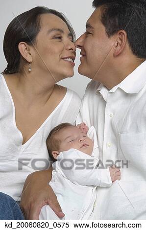 Hispanic parents hugging with baby View Large Photo Image Stock Photography - Hispanic parents hugging with baby. Fotosearch