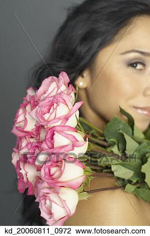 Hispanic woman holding bouquet of flowers View Large Photo Image Stock Image - Hispanic woman holding bouquet of flowers. Fotosearch
