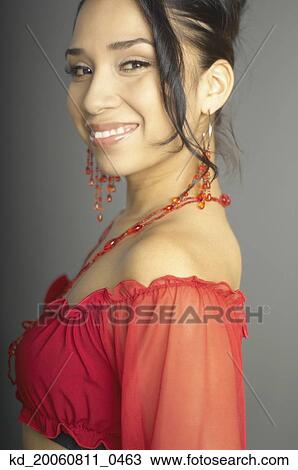 Stock Image - Hispanic woman wearing matching jewelry. Fotosearch