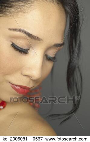 Stock Photo - Hispanic woman with eyes closed. Fotosearch