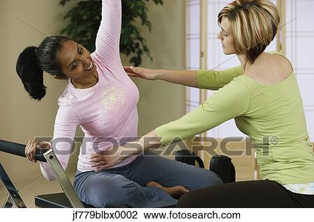 Indian woman exercising with personal trainer View Large Photo Image Stock Image - Indian woman exercising with personal trainer. Fotosearch