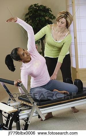 Indian woman exercising with personal trainer View Large Photo Image Stock Photograph - Indian woman exercising with personal trainer. Fotosearch