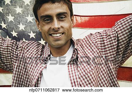 Man holding up American flag View Large Photo Image Stock Photo - Man holding up American flag. Fotosearch