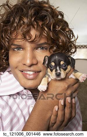 Stock Photograph - Middle Eastern man holding puppy. Fotosearch