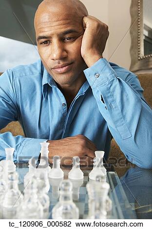 Mixed Race man playing chess View Large Photo Image Stock Image - Mixed Race man playing chess. Fotosearch