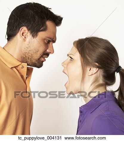 Stock Image - Mixed Race woman yelling at boyfriend. Fotosearch