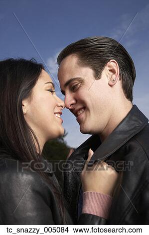 Multi-ethnic couple hugging outdoors View Large Photo Image Picture - Multi-ethnic couple hugging outdoors. Fotosearch