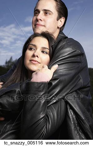 Multi-ethnic couple hugging outdoors View Large Photo Image Stock Photograph - Multi-ethnic couple hugging outdoors. Fotosearch