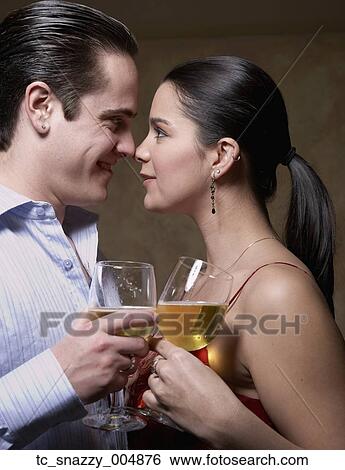 Stock Photograph - Multi-ethnic couple smiling at each other. Fotosearch