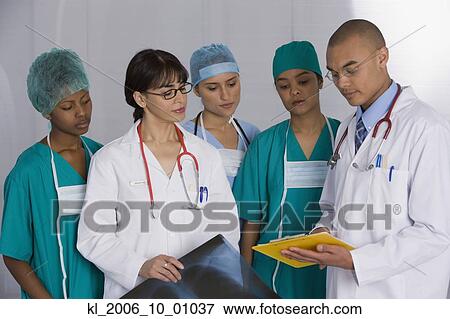 Stock Photo - Multi-ethnic doctors discussing chart. Fotosearch