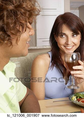 Stock Photo - Multi-ethnic friends at restaurant. Fotosearch