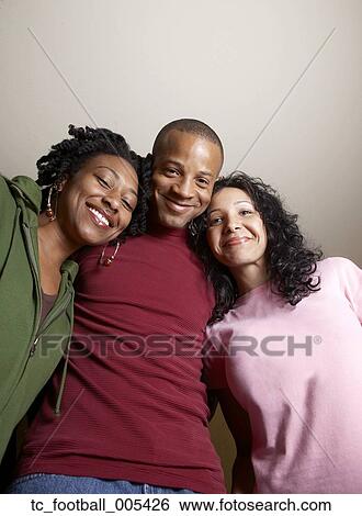 Multi-ethnic friends hugging View Large Photo Image Stock Photograph - Multi-ethnic friends hugging. Fotosearch