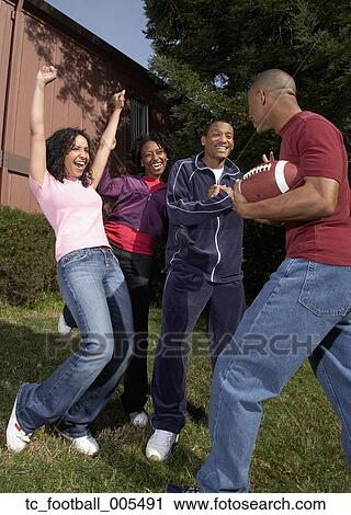 Multi-ethnic friends playing football View Large Photo Image Stock Image - Multi-ethnic friends playing football. Fotosearch