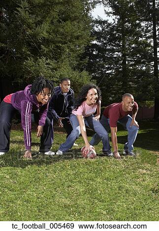 Multi-ethnic friends playing football View Large Photo Image Stock Photo - Multi-ethnic friends playing football. Fotosearch