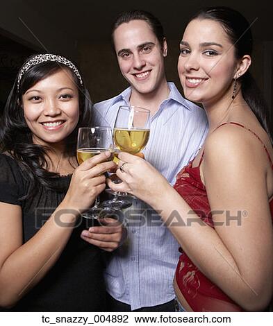 Stock Image - Multi-ethnic friends toasting with wine. Fotosearch