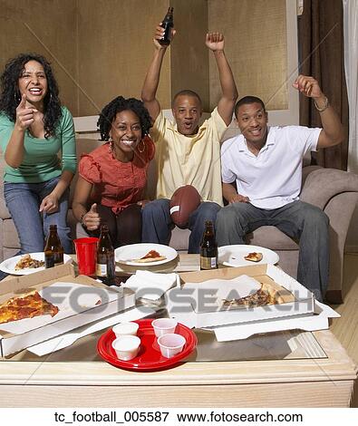 Multi-ethnic friends watching sports on television View Large Photo Image Stock Photo - Multi-ethnic friends watching sports on television. Fotosearch