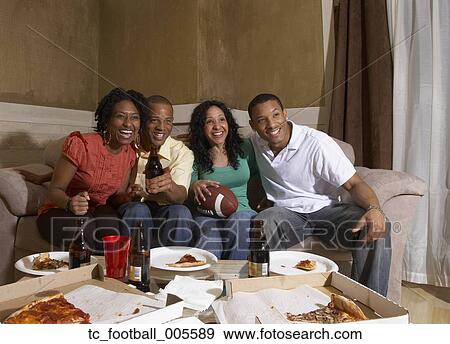 Multi-ethnic friends watching sports on television View Large Photo Image Stock Photo - Multi-ethnic friends watching sports on television. Fotosearch