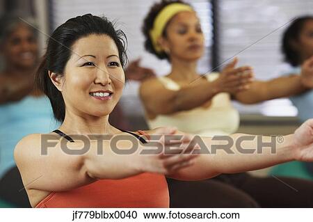 Stock Image - Multi-ethnic women in exercise class. Fotosearch