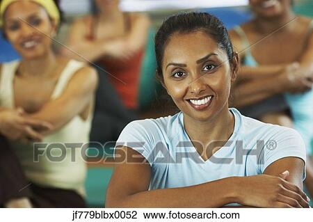Stock Image - Multi-ethnic women in exercise class. Fotosearch