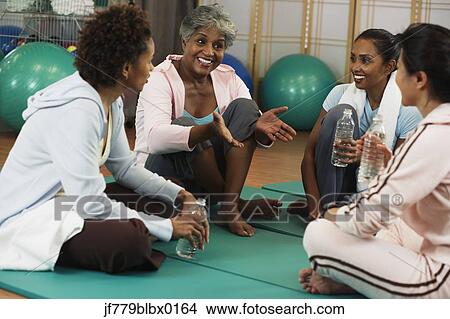 Multi-ethnic women talking at health club View Large Photo Image Picture - Multi-ethnic women talking at health club. Fotosearch