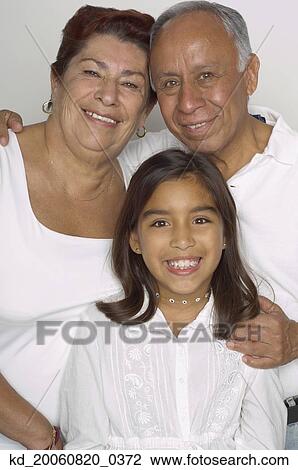 Stock Image - Portrait of Hispanic grandparents and granddaughter. Fotosearch