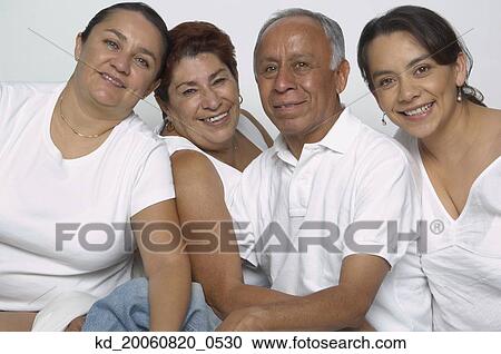 Stock Image - Portrait of Hispanic parents and adult daughters. Fotosearch