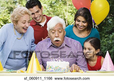 Senior Hispanic man blowing out birthday candles with family in park View Large Photo Image Stock Photograph - Senior Hispanic man blowing out birthday candles with family in park. Fotosearch
