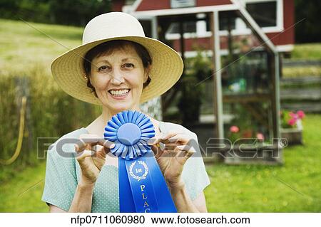 Stock Image - Woman holding blue ribbon . Fotosearch