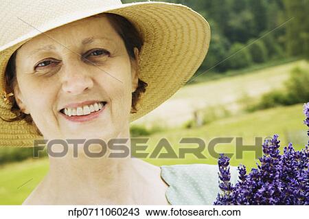 Stock Image - Woman wearing sun hat. Fotosearch