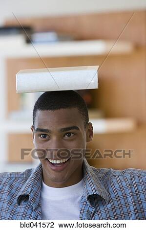 African man balancing book on head View Large Photo Image Stock Image - African man balancing book on head. Fotosearch